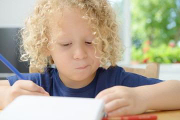 boy drawing on a notebook