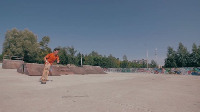 Skateboarder jumping in a city skate park. Skow motion. HD.