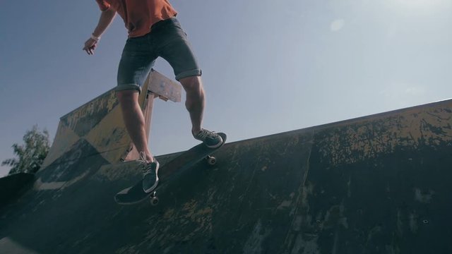 Skateboarder jumping in a city skate park. Skow motion. HD.