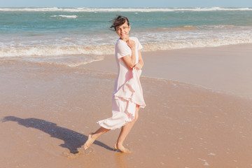 Woman legs walking on the beach sand