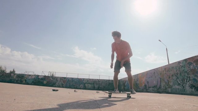 Skateboarder doing tricks in a city. HD.