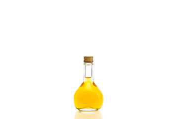 Pear-shaped bottle with yellow liquid inside