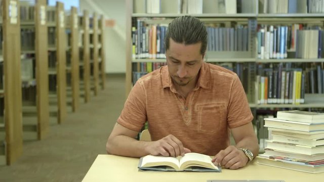 Man reading books in library