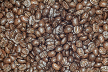Coffee beans closeup. Roasted brown coffee beans texture or coffee beans background for design.