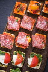 spanish tapas on wooden board, selective focus