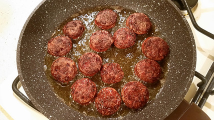 Fragrant smoked sausage with spices fried in a pan