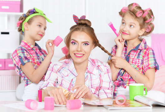 girls with mother   in hair curlers 
