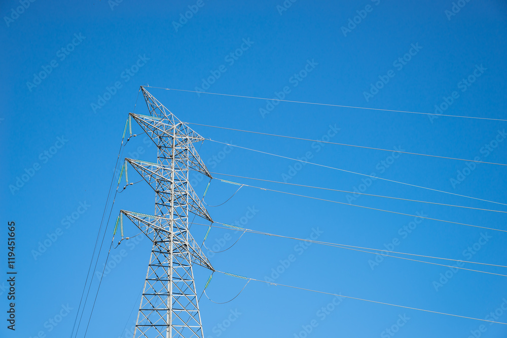 Wall mural electricity transmission pylon against blue sky