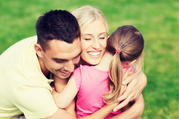 Obraz premium happy family hugging outdoors