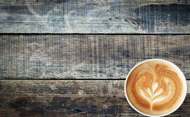 Coffee cup on old wood texture background.