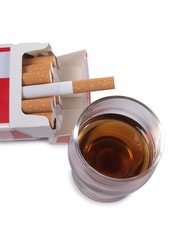 Cigarettes and glass of wine on white background