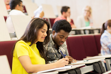 group of students with notebooks in lecture hall