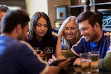 football fans or friends with beer at sport bar