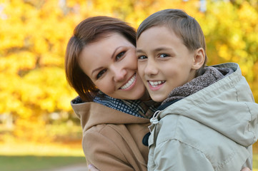 Fototapeta na wymiar Mother with son in autumn park