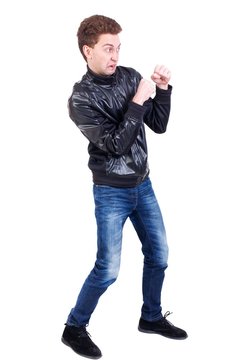 back view of guy funny fights waving his arms and legs. Curly guy in a black leather jacket with a funny expression on his face fighting with their fists.