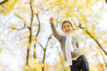 Little girl in the autumn park