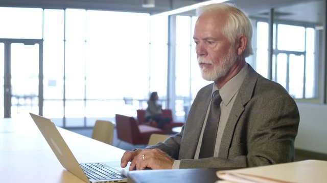 Elderly man using laptop