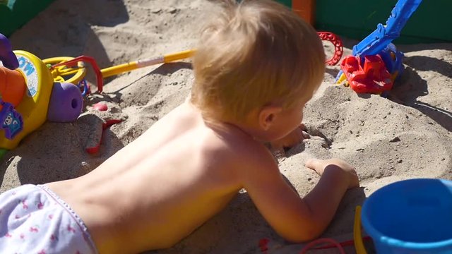 a child plays in the sandbox