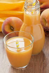 Peach juice drink / Glass fresh peach juice and ripe peach on wooden background