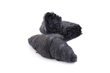 Black croissant of active charcoal on white background