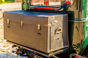 old leather suitcase on vintage car