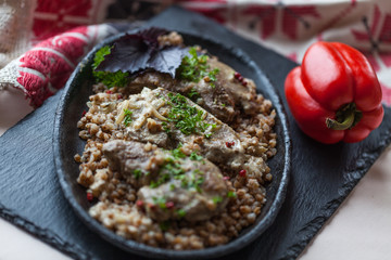 Buckwheat with braised pork in a frying pan
