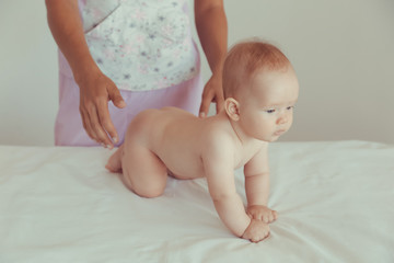 Masseur doing massage a small baby.