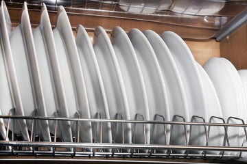 dishes after washing in fitted cupboard