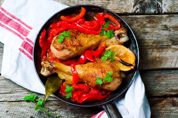 chicken drumsticks with a pepper  in a frying pan.