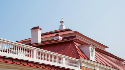 Ancient roof with chimneys, tower and attic