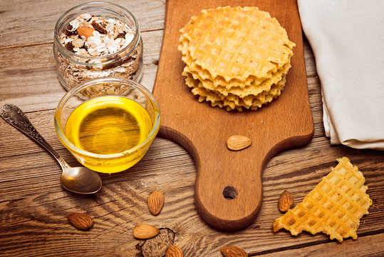 Waffles with  nuts and  honey on rustic wood background. Belgian waffles  on  wood table background