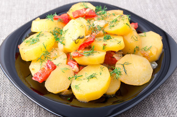 Potatoes with onion, bell pepper and fennel on the surface of th