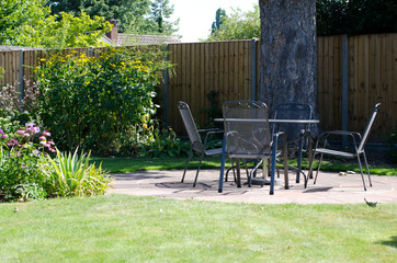 Patio with table and chairs in garden