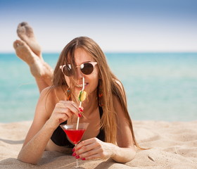 Sea. Black bikini sea drink cocktail, close up, sand, smile