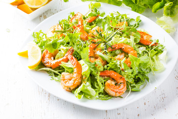Seafood shrimp lettuce salad on white plate