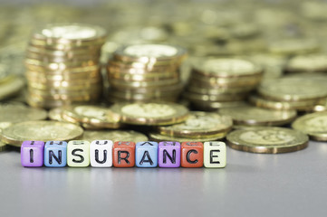 Insurance text and gold coins