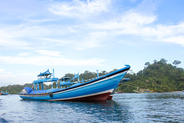 Sendang biru beach in the southern part of Malang, east java indonesia with long tail boat, sail boat, and yacht