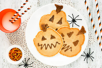 Halloween theme pancakes on white table with spider