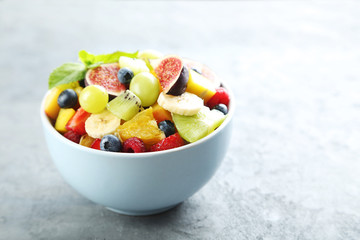 Fresh fruit salad on a grey wooden table