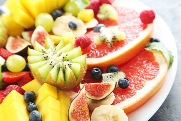 Fresh fruit salad on a grey wooden table