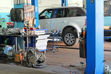 Car on a lift in a car repair station 