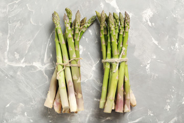 Fresh green asparagus on a grey table