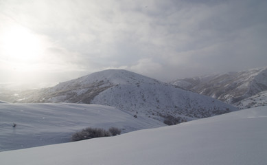 Fototapeta na wymiar dawn sun in the snowy mountains of Kazakhstan