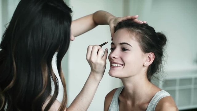 Female beauty, beautiful woman and professional makeup artist
