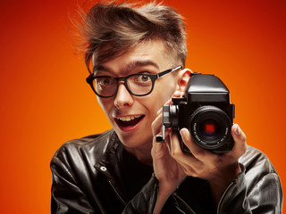 Emotional portrait of a teenager with film camera