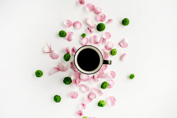 Colorful bright image made of leaves, roses and petals with coffee cup on white. flat lay, top view