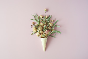 waffle cone with roses bouquet on pink background, flat lay, top view