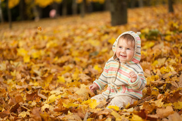 Small girl in autumn park