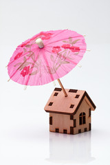 Wooden house and cocktail umbrella./Wooden house and cocktail umbrella.