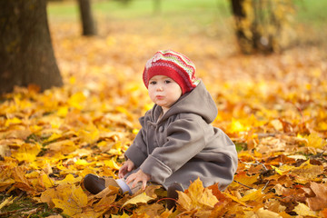 Small girl in autumn park